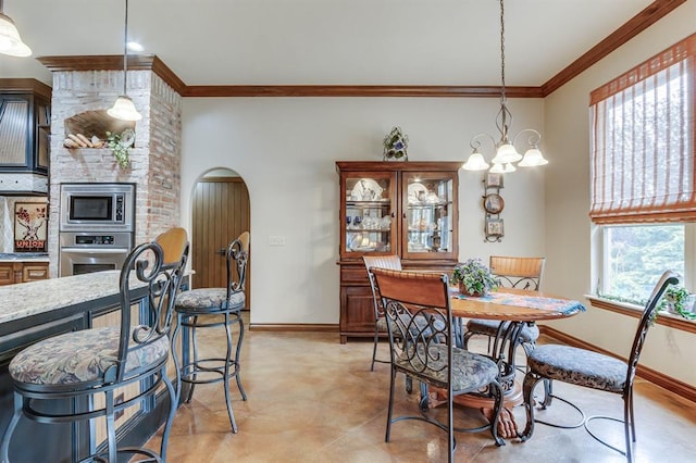 16204 Old Olive Way, Edmond, OK 73013 - dining space featuring ornamental molding, a chandelier, and arched walkways