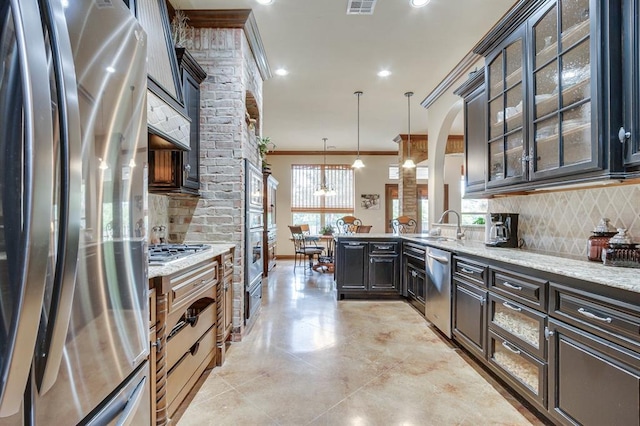 16204 Old Olive Way, Edmond, OK 73013 - kitchen featuring appliances with stainless steel finishes, decorative backsplash, ornamental molding, healthy amount of natural light, and recessed lighting