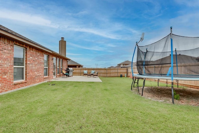 11316 NW 94th St, Yukon, OK 73099 - fenced backyard featuring a trampoline and a patio area