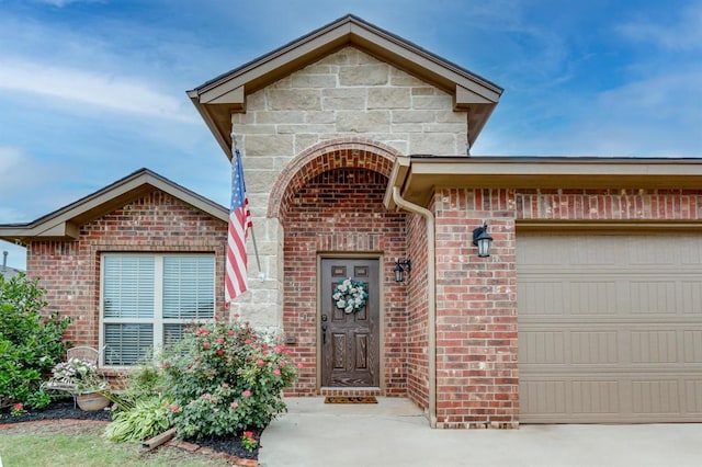 11316 NW 94th St, Yukon, OK 73099 - view of exterior entry with a garage and brick siding