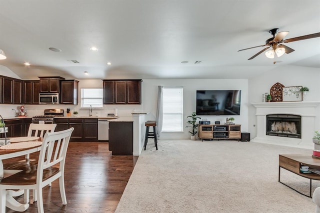 11316 NW 94th St, Yukon, OK 73099 - living area featuring lofted ceiling, a fireplace with raised hearth, ceiling fan, recessed lighting, and dark wood-style floors