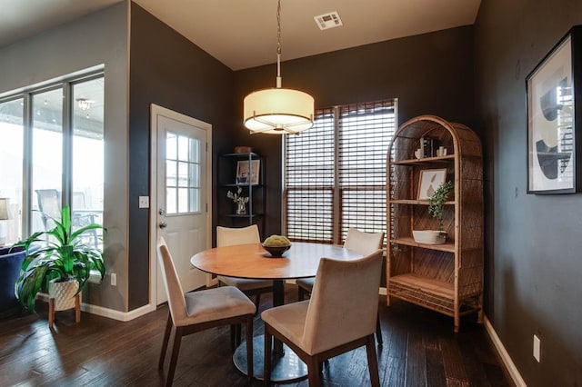9124 NW 90th Cir, Yukon, OK 73099 - dining space featuring dark wood-style flooring and plenty of natural light