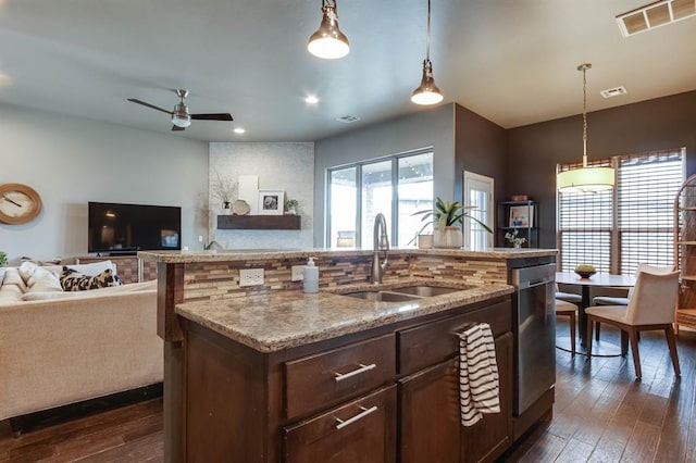 9124 NW 90th Cir, Yukon, OK 73099 - kitchen featuring dishwasher, dark wood finished floors, light stone countertops, open floor plan, and pendant lighting