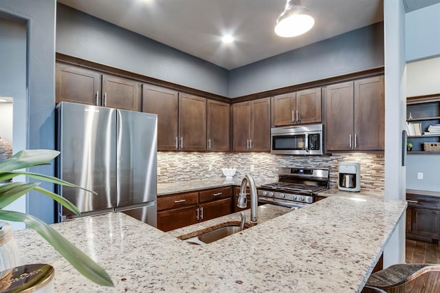 9124 NW 90th Cir, Yukon, OK 73099 - kitchen featuring stainless steel appliances, tasteful backsplash, and light stone countertops