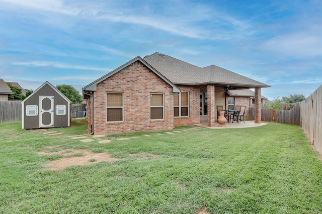 9124 NW 90th Cir, Yukon, OK 73099 - back of property featuring brick siding, a fenced backyard, a storage shed, and a patio area