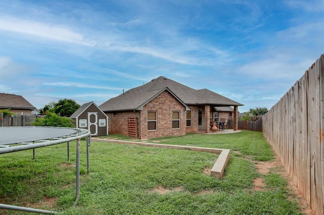 9124 NW 90th Cir, Yukon, OK 73099 - rear view of property featuring brick siding, a storage shed, a fenced backyard, a patio area, and a shingled roof