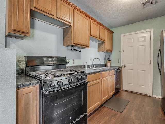 2028 Carlisle Rd, The Village, OK 73120 - kitchen featuring black appliances, dark wood-style flooring, dark countertops, a textured ceiling, and a textured wall