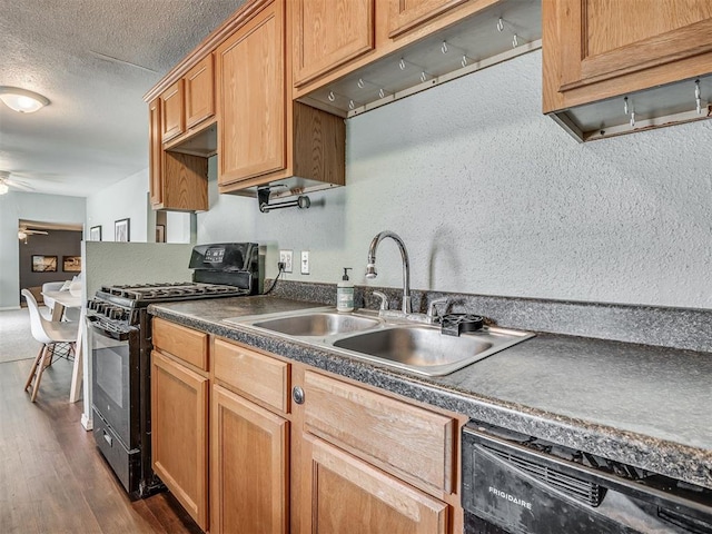 2028 Carlisle Rd, The Village, OK 73120 - kitchen featuring black appliances, dark countertops, dark wood-type flooring, a ceiling fan, and a textured ceiling