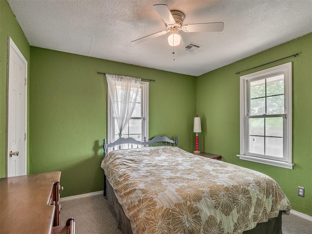 2028 Carlisle Rd, The Village, OK 73120 - carpeted bedroom featuring ceiling fan, a textured ceiling, and a textured wall