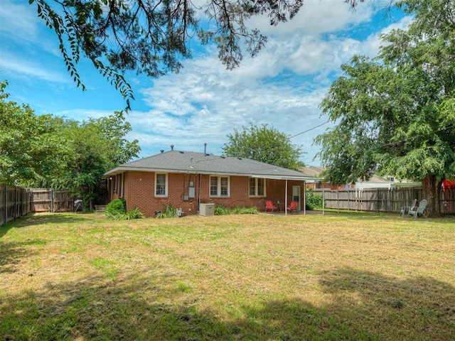2028 Carlisle Rd, The Village, OK 73120 - back of property featuring brick siding and a fenced backyard