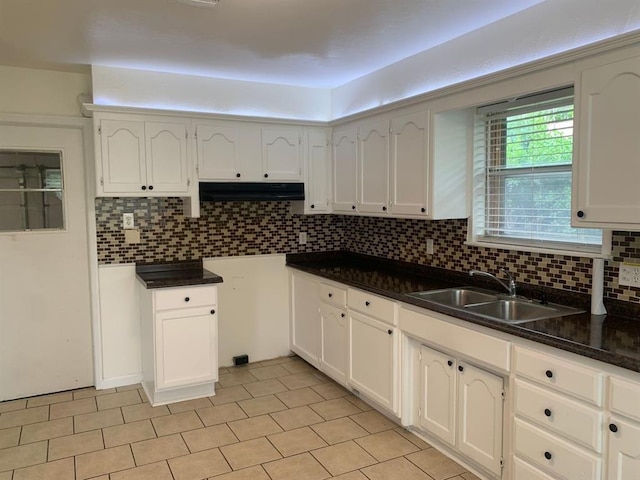 2928 N Downing Ave, Bethany, OK 73008 - kitchen featuring tasteful backsplash, under cabinet range hood, dark countertops, and light tile patterned floors