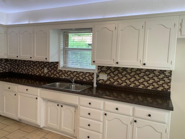2928 N Downing Ave, Bethany, OK 73008 - kitchen with tasteful backsplash, light tile patterned floors, and white cabinets