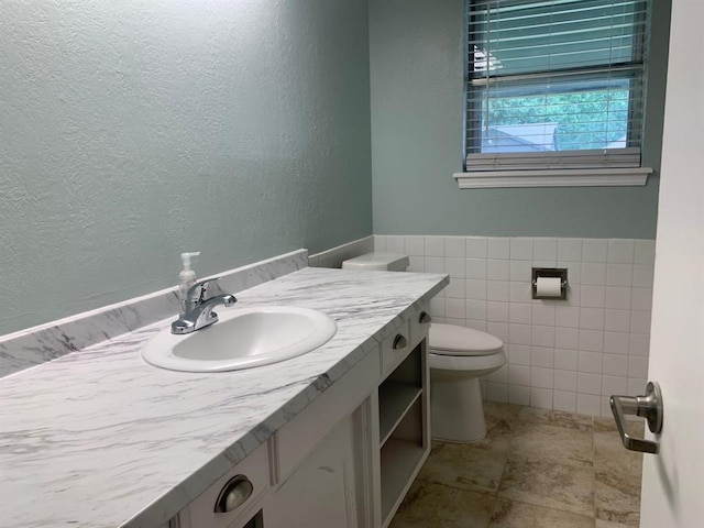 2928 N Downing Ave, Bethany, OK 73008 - bathroom with vanity, tile walls, and a textured wall