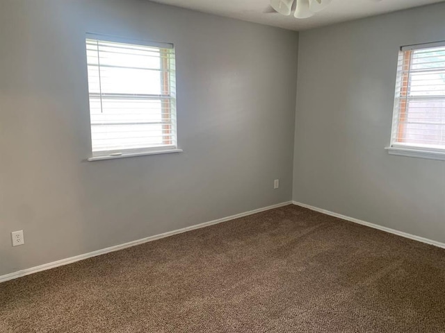 2928 N Downing Ave, Bethany, OK 73008 - unfurnished room featuring dark colored carpet and baseboards