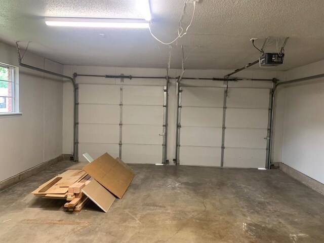 2928 N Downing Ave, Bethany, OK 73008 - garage with a garage door opener and baseboards