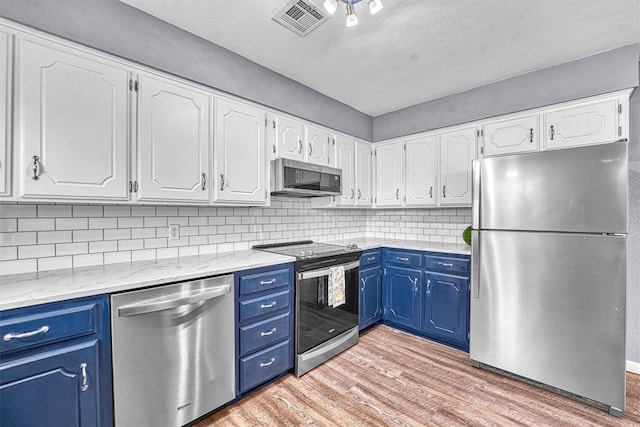 224 N Quail Run, Altus, OK 73521 - kitchen featuring stainless steel appliances, blue cabinetry, light wood-type flooring, and white cabinetry