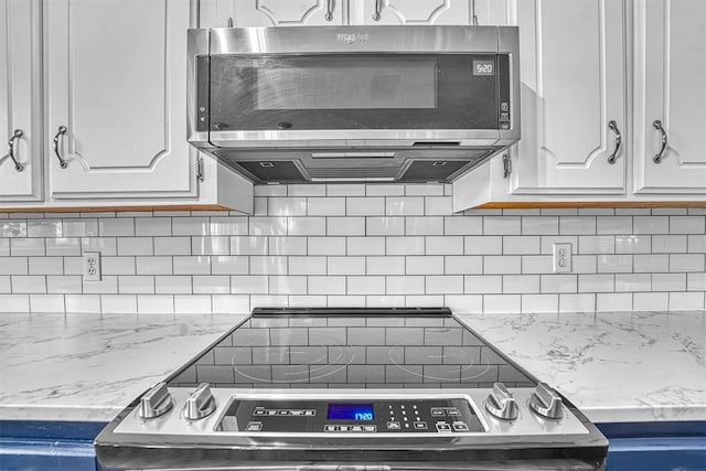 224 N Quail Run, Altus, OK 73521 - kitchen with appliances with stainless steel finishes, white cabinets, tasteful backsplash, and light stone countertops