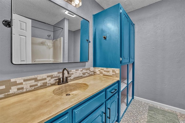 224 N Quail Run, Altus, OK 73521 - full bath featuring tasteful backsplash, vanity, a textured ceiling, a textured wall, and a shower