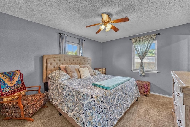 224 N Quail Run, Altus, OK 73521 - bedroom with carpet floors, a textured ceiling, a textured wall, and ceiling fan