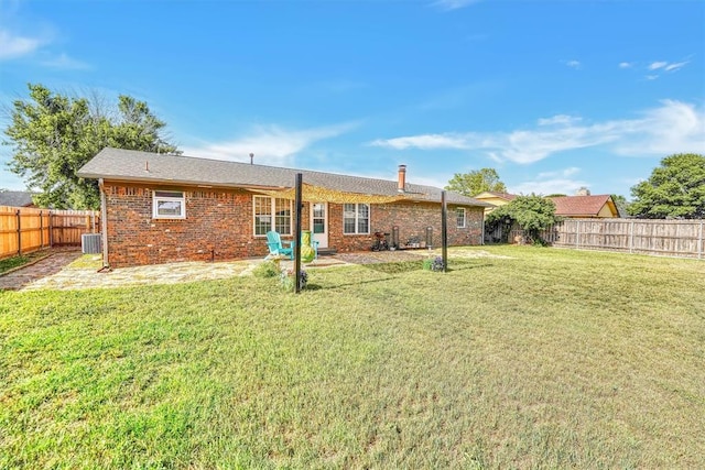 224 N Quail Run, Altus, OK 73521 - back of property featuring a fenced backyard, brick siding, and a patio area
