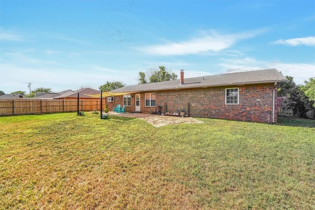224 N Quail Run, Altus, OK 73521 - rear view of house featuring a fenced backyard, brick siding, and a patio