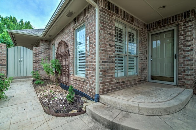 1900 NW 159th Pl, Edmond, OK 73013 - view of exterior entry with brick siding and a gate