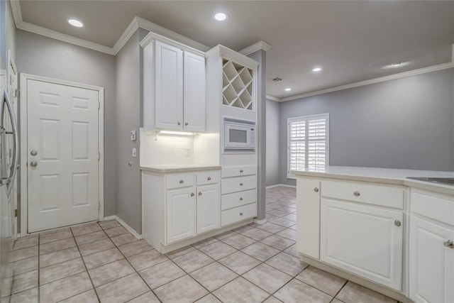 1900 NW 159th Pl, Edmond, OK 73013 - kitchen featuring crown molding, light tile patterned flooring, white cabinetry, light countertops, and recessed lighting