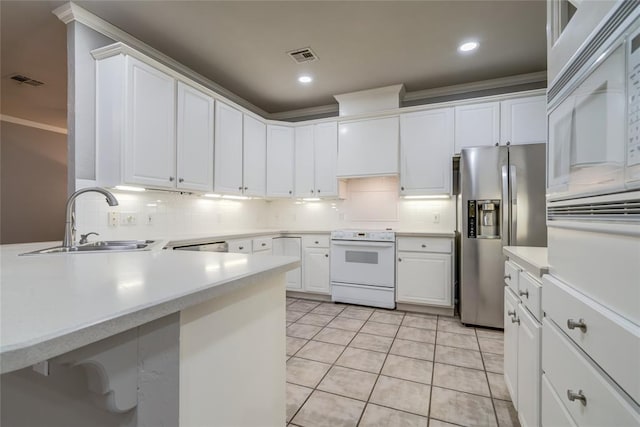 1900 NW 159th Pl, Edmond, OK 73013 - kitchen featuring white range oven, stainless steel fridge with ice dispenser, decorative backsplash, light tile patterned floors, and light countertops