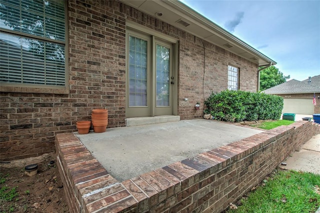 1900 NW 159th Pl, Edmond, OK 73013 - doorway to property featuring brick siding and a patio area