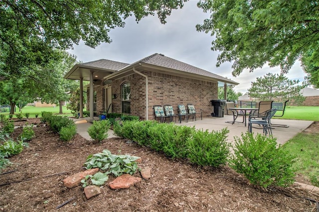 1900 NW 159th Pl, Edmond, OK 73013 - back of house with brick siding, a patio, and roof with shingles