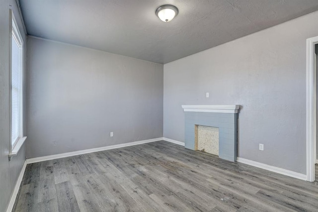2132 N Rhode Island Ave, Oklahoma City, OK 73111 - unfurnished living room with wood finished floors and a fireplace