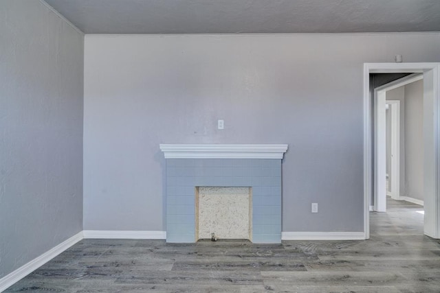 2132 N Rhode Island Ave, Oklahoma City, OK 73111 - unfurnished living room with wood finished floors and a fireplace