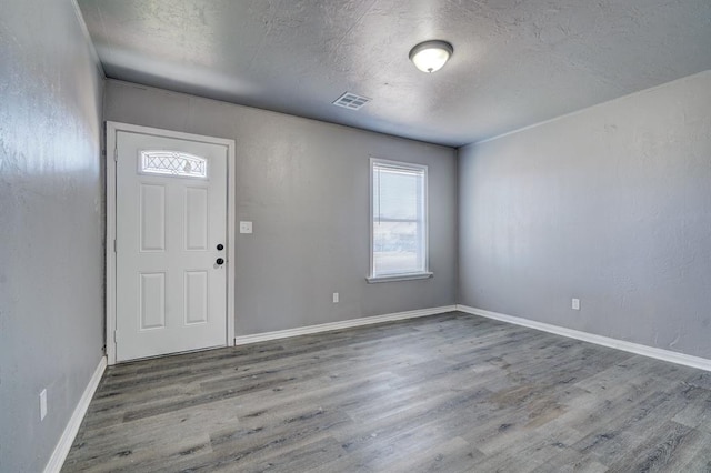 2132 N Rhode Island Ave, Oklahoma City, OK 73111 - entryway with wood finished floors and a textured ceiling