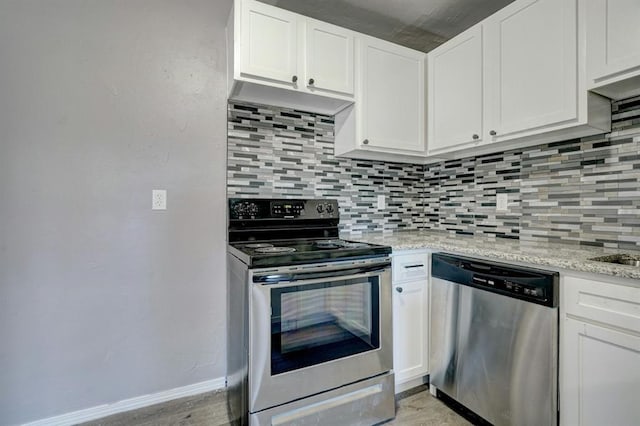 2132 N Rhode Island Ave, Oklahoma City, OK 73111 - kitchen featuring appliances with stainless steel finishes, tasteful backsplash, and white cabinets