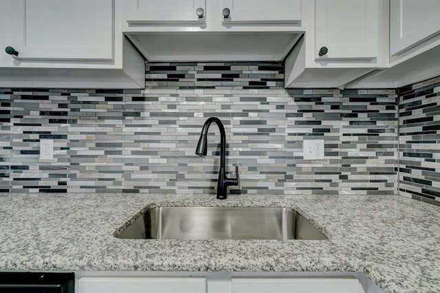 2132 N Rhode Island Ave, Oklahoma City, OK 73111 - kitchen featuring backsplash and light stone countertops