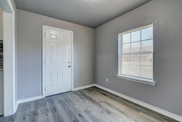 2132 N Rhode Island Ave, Oklahoma City, OK 73111 - spare room featuring wood finished floors and baseboards