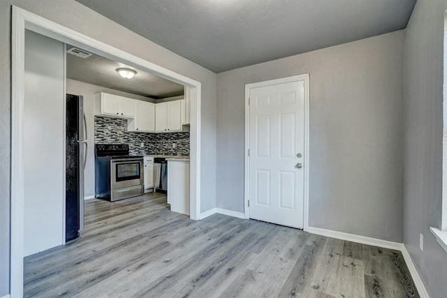 2132 N Rhode Island Ave, Oklahoma City, OK 73111 - kitchen with appliances with stainless steel finishes, light wood-style flooring, white cabinetry, tasteful backsplash, and light countertops