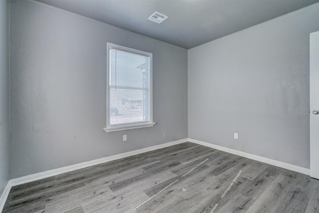 2132 N Rhode Island Ave, Oklahoma City, OK 73111 - spare room with wood finished floors and baseboards