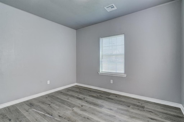 2132 N Rhode Island Ave, Oklahoma City, OK 73111 - spare room featuring wood finished floors and baseboards