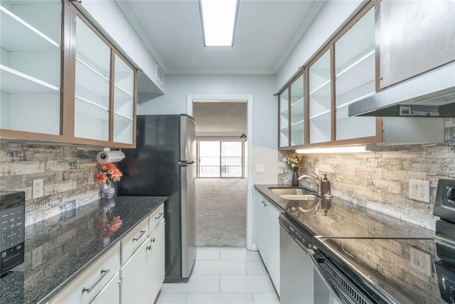 6100 N Brookline Ave Unit 20, Oklahoma City, OK 73112 - kitchen with stainless steel appliances, backsplash, ornamental molding, light colored carpet, and white cabinets