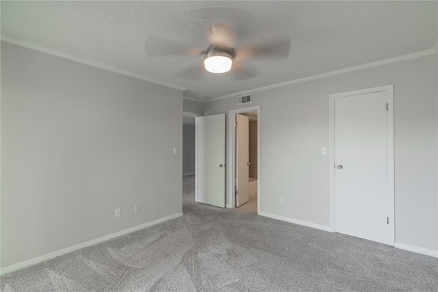 6100 N Brookline Ave Unit 20, Oklahoma City, OK 73112 - unfurnished bedroom featuring crown molding, carpet flooring, ceiling fan, and a textured ceiling
