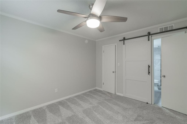 6100 N Brookline Ave Unit 20, Oklahoma City, OK 73112 - carpeted spare room with a ceiling fan, crown molding, and a barn door