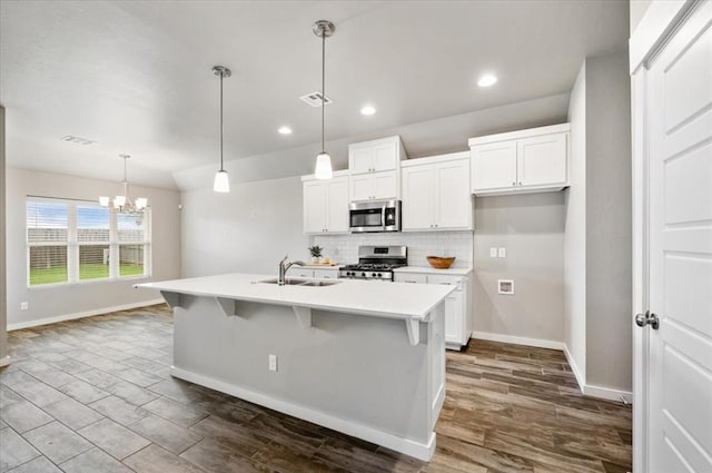 2020 Sara Vista Dr, Yukon, OK 73099 - kitchen featuring stainless steel appliances, backsplash, white cabinets, a chandelier, and recessed lighting