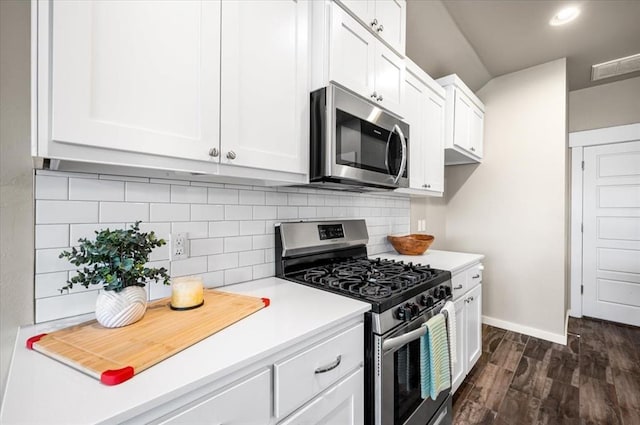 2020 Sara Vista Dr, Yukon, OK 73099 - kitchen with stainless steel appliances, white cabinets, light countertops, dark wood-type flooring, and decorative backsplash