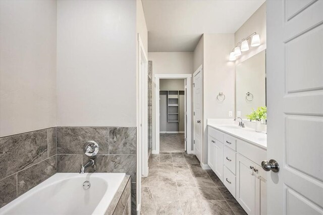 2020 Sara Vista Dr, Yukon, OK 73099 - full bathroom with double vanity, a bath, and a walk in closet