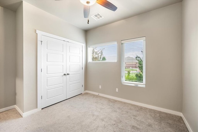 2020 Sara Vista Dr, Yukon, OK 73099 - unfurnished bedroom with light colored carpet, a closet, and a ceiling fan
