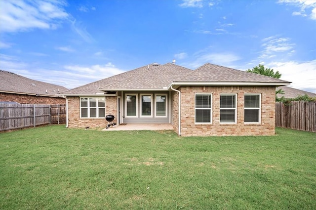 2020 Sara Vista Dr, Yukon, OK 73099 - back of property with brick siding, a fenced backyard, roof with shingles, and a patio area