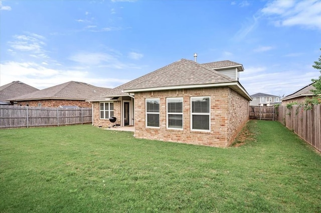 2020 Sara Vista Dr, Yukon, OK 73099 - rear view of house with a fenced backyard, brick siding, and roof with shingles