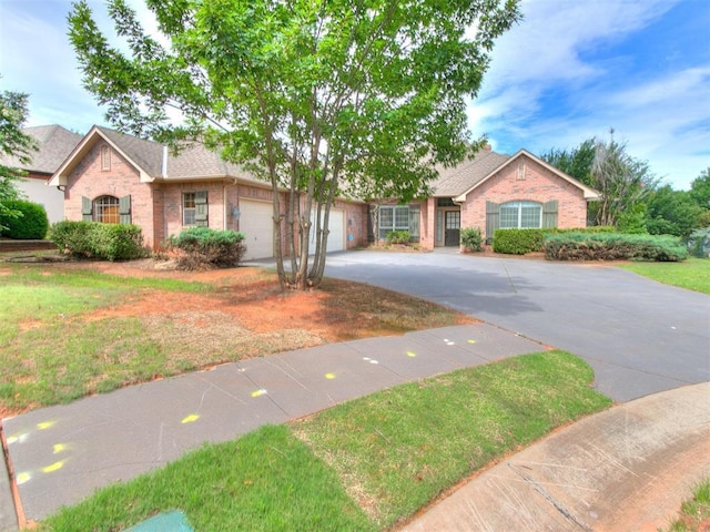 112 Lakeview Ct, Edmond, OK 73003 - single story home with brick siding, concrete driveway, a garage, a front yard, and roof with shingles