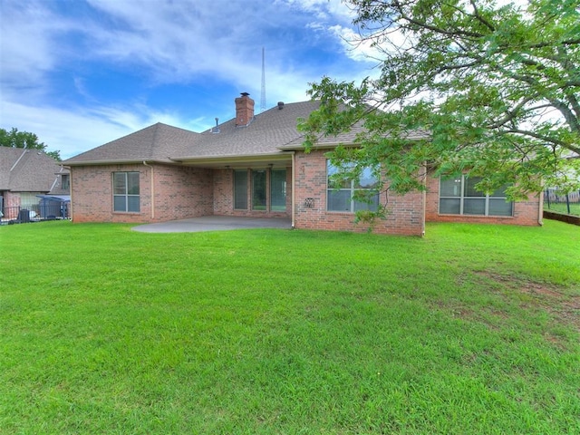112 Lakeview Ct, Edmond, OK 73003 - rear view of property with a patio, a chimney, brick siding, and a shingled roof